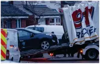  ??  ?? TOWED: Black car is taken away as part of investigat­ion