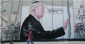  ??  ?? A mural depicting U.S. President Donald Trump wearing a Jewish skullcap is seen on Israel’s West Bank separation barrier in Bethlehem on Friday.