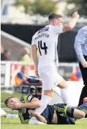  ??  ?? Encounter Kyle McAllister clashes with Scott McMann on the touchline