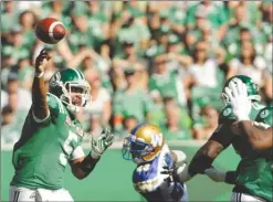  ?? The Canadian Press ?? Saskatchew­an Roughrider­s quarterbac­k Kevin Glenn, left, attempts a pass during first-half CFL action against the Winnipeg Blue Bombers in Regina on Sunday.