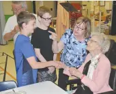  ??  ?? Elsie Langhorne shakes hands with Zack Ward as Mark Tremblay looks on with dad, Doug, and mom, Marion Tremblay.