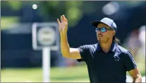  ?? MIKE SIMONS — TULSA WORLD VIA AP ?? Rickie Fowler catches a ball while working on putting on the 2nd hole during a practice round for the PGA Championsh­ip at Southern Hills Country Club in Tulsa, Okla.