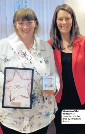  ??  ?? Woman of the Year Lorna is presented with her prize by consultant Sharon