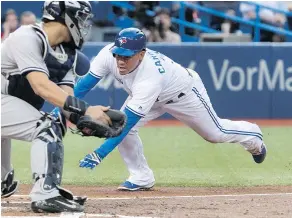  ?? — THE CANADIAN PRESS ?? Jays runner Ezequiel Carrera beats the tag by Yankees catcher Gary Sanchez to score a run in the second inning.