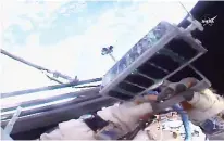  ?? NASA via AP ?? n In this image made from video provided by NASA, Russian cosmonaut Sergei Ryazansky holds a mini satellite before launching it by hand on Thursday from the Internatio­nal Space Station.