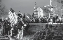  ?? JASON ANDREW/THE NEW YORK TIMES ?? Supporters of then-President Donald Trump face police Jan. 6 outside the U.S. Capitol. Five people, including a police officer, died in a riot that day.