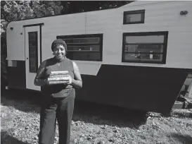  ?? SHAWN DOWD/ROCHESTER DEMOCRAT AND CHRONICLE ?? Taylor Thomas stands with a trailer that will be the rolling home of her book store, Archivist Books, on July 19.