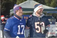  ??  ?? Christmas Eve Bowl founder Erik Geckler, left, and Shane Kalil, one of the leaders with Cub Scout Pack #24, right, watch the action at the fourth annual Christmas Eve Bowl on Tuesday in Wilton.