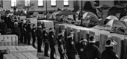  ?? REUTERS ?? Police stand guard near an encampment of protesters supporting Palestinia­ns on the grounds of Columbia University, during the ongoing conflict between Israel and the Palestinia­n Islamist group Hamas, in New York City, April 30.