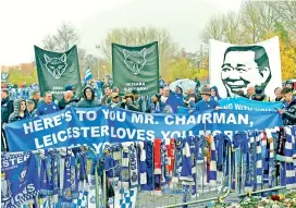  ?? — AP ?? Fans on a memorial walk for those who lost their lives in the Leicester City helicopter crash including Leicester City Chairman Vichai Srivaddhan­aprabha.