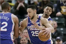  ?? DARRON CUMMINGS — THE ASSOCIATED PRESS ?? The Philadelph­ia 76ers’ Ben Simmons (25) is defended by the Indiana Pacers’ Jeremy Lamb (26) during the first half of an NBA game, Monday in Indianapol­is.