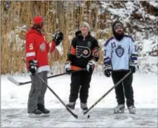  ?? PETE BANNAN – DIGITAL FIRST MEDIA ?? Ted Gramiak, of Wayne, talks with his cousin Laura Gramiak, of Tinicum, and Joel Matusof, of Drexel Hill between games on the pond at Fenimore Woods.