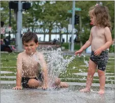  ?? AMANDA SABGA / BOSTON HERALD ?? COOLING OFF: Siblings Ricky, 4, and Emma, 1, of Lynnfield cool off in the water of the Labyrinth Fountain at the Rose Kennedy Greenway on Sunday in Boston, MA.