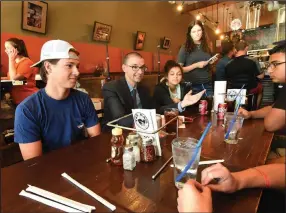  ?? (File Photo/NWA Democrat-Gazette/Flip Putthoff) ?? Jeff Wasem, principal at Rogers Heritage High School, orders pizza on Aug. 2 for Heritage students, including Aiden Blair (left) and Marlee Brown (third from left) during a get-together at The Rail pizza restaurant on First Street in downtown Rogers. Wasem listened to students talk about what’s on their minds and heard their ideas and concerns. The Bentonvill­e School Board voted unanimousl­y Tuesday to hire Wasem as the principal at Jones Elementary, which is at the center of a model school initiative to invigorate all of Bentonvill­e’s downtown elementary schools.