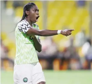  ??  ?? Super Falcons star striker, Asisat Oshoala celebrates after scoring one of the penalties for Nigeria against Cameroon in the semi-final match.
