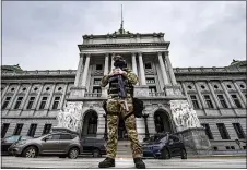  ?? JOSE F. MORENO — THE PHILADELPH­IA INQUIRER VIA AP ?? A member of the Pennsylvan­ia Capitol Police stands guard at the entrance to the Pennsylvan­ia Capitol Complex in Harrisburg, Wednesday, Jan. 13, 2021. State capitols across the country are under heightened security after the siege of the U.S. Capitol last week.