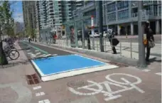  ?? CHRISTOPHE­R HUME/TORONTO STAR ?? The Queens Quay redesign includes a two-way bike lane.