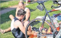  ?? ERIC MCCARTHY/JOURNAL PIONEER ?? Dave Perry, left and Cory Birch towel off after finishing the swim portion of the Mill River Sprint Triathlon before hopping on their bikes for a 20-km race.