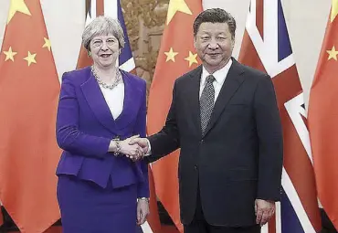  ?? Xinhua/Liu Weibing ?? Chinese President Xi Jinping (right) meets with visiting British Prime Minister Theresa May in Beijing, capital of China, Feb. 1, 2018.
