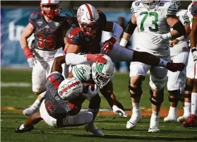  ?? Matt Strasen / Associated Press ?? Miami (Ohio) defensive back Cecil Singleton (2) and defensive lineman Kameron Butler tackle North Texas running back Ikaika Ragsdale in the first half of the Frisco Football Classic. Miami (7-6) won, its first bowl-game victory since the 2010 season.