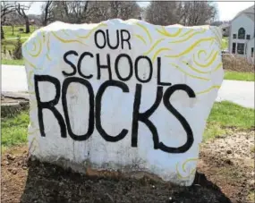  ?? CHRIS BARBER — DIGITAL FIRST MEDIA ?? The students have painted a large stone in the front lawn to express their affection for Avon Grove Charter School.