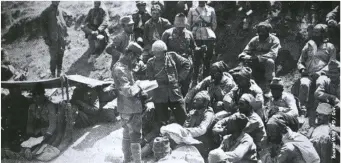  ??  ?? ABOVE: A Greek interprete­r talks to Turkish prisoners. The Turks would eventually expel the Greek population from Turkey after the war
BELOW: The Greek 9th Division marching through central Anatolia in August 1921. The Greeks were initially successful in the war but were hindered by poor leadership and planning, and a lack of internatio­nal support