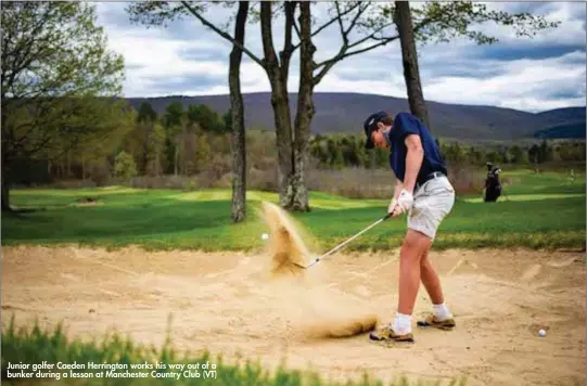  ??  ?? Junior golfer Caeden Herrington works his way out of a bunker during a lesson at Manchester Country Club (VT)