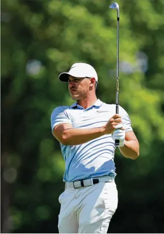  ?? ANDY LYONS / GETTY IMAGES ?? Brooks Koepka plays a shot on the first hole Saturday of the third round of the PGA Championsh­ip at Bellerive Country Club in St. Louis. The U.S. Open champ leads by two shots.