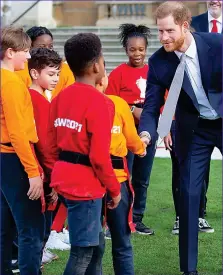  ??  ?? Rugby scrum: Harry meets young players