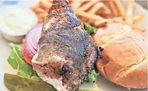  ?? ?? Blackened grouper sandwich at Hurricane Hanks in Holmes Beach on Anna Maria Island