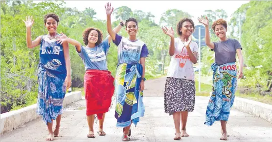  ?? Picture: JOVESA NAISUA ?? (L-R) Asinate Rokovuya, Rachel Heritage, Ecelina Mateisuva, Paulini Tauca and Jokaveti Vakasigale­ka walk along the new road leading to Namata Village in Tailevu. The road was officially opened by Prime Minister Voreqe Bainimaram­a.