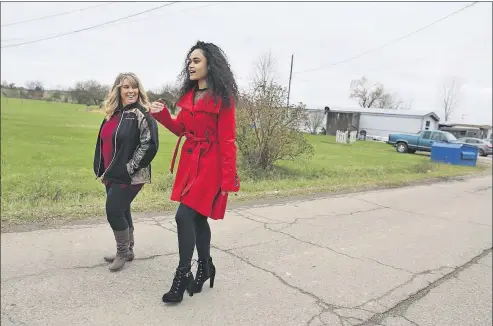  ?? [JONATHAN QUILTER/DISPATCH] ?? Sariah Brady, right, walks with her adoptive mother, Corena Brady, from their home in Danville to the family’s car-repair shop down the street. The city-born 18-year-old endured 15 years of a mostly anguished childhood before arriving in Knox County as...