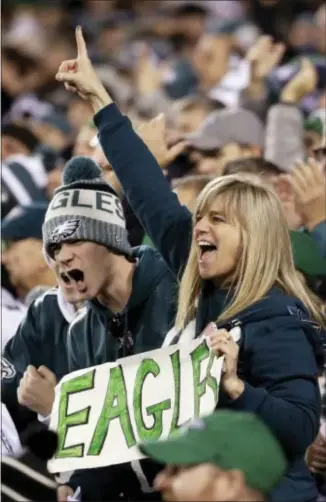  ?? ASSOCIATED PRESS ?? Fans cheer during the first half of Sunday night’s NFC Championsh­ip Game at the Linc in South Philly. The Eagles romped over the Vikings to advance to play the Patriots in the Super Bowl.