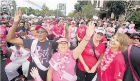  ?? PHOTOS BY STEPHEN M. DOWELL/ORLANDO SENTINEL ?? Marchers crowd the downtown streets during the Making Strides Against Breast Cancer Walk at Lake Eola Park on Saturday.