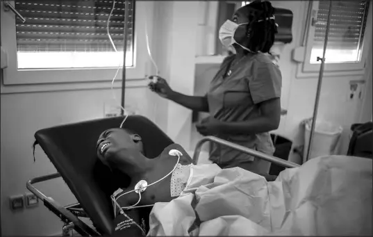  ?? RAMON ESPINOSA / ASSOCIATED PRESS ?? Christo Brams, 11, who was injured by a stray bullet, writhes in pain Nov. 3 at the emergency room at a clinic run by Doctors Without Borders in the Tabarre neighborho­od of Port-au-prince, Haiti.