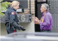  ?? GAVIN YOUNG/Postmedia News ?? A squatter speaks with a police officer outside the Parkdale duplex at the centre of a legal battle involving the Freeman-On-The-Land movement on Thursday. The remaining squatters left the residence without incident
Friday evening after Andreas...