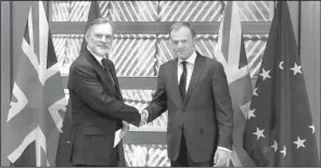  ?? AP/YVES HERMAN ?? Britain’s European Union representa­tive Tim Barrow (left) delivers the United Kingdom’s notice of its intent to exit the bloc to EU Council President Donald Tusk on Wednesday in Brussels.