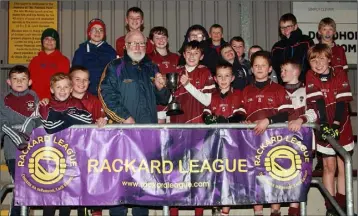  ??  ?? Kevin Waters (Rackard League Chairman) presenting the trophy to Castletown captain Fionn Kavanagh.