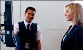  ?? TRIBUNE NEWS SERVICE ?? A Delta employee guides someone through facial recognitio­n boarding.