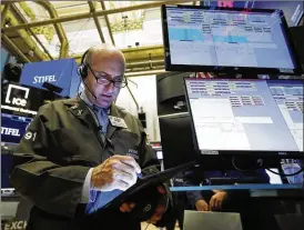  ?? RICHARD DREW / ASSOCIATED PRESS ?? Trader Andrew Silverman works Tuesday at the New York Stock Exchange. Markets turned higher Tuesday as China stabilized its currency after letting it depreciate in response to a U.S. plan to put more tariffs on Chinese goods.