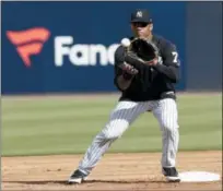  ?? LYNNE SLADKY — THE ASSOCIATED PRESS ?? Russell Wilson does fielding drills at Yankees camp, Monday in Tampa, Fla.