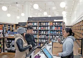  ?? [AP PHOTO] ?? Customers buy books Monday at an Amazon Books store in New York. Amazon goes into the holiday season with a newly magnified brick-and-mortar presence, giving it more opportunit­ies to sell its Kindle e-readers, Fire tablets and other gadgets. The online...