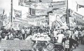  ?? — AFP photo ?? Electoral banners are displayed in the Ndjili district of Kinshasa after campaignin­g for Democratic Republic of Congo’s general elections was called off in Kinshasa by the authoritie­s on security grounds.