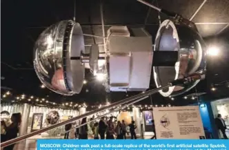  ??  ?? MOSCOW: Children walk past a full-scale replica of the world’s first artificial satellite Sputnik, launched by the Soviet Union from a testing range in Kazakhstan yesterday, at the Memorial Museum of Cosmonauti­cs (or Memorial Museum of Space...