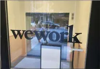  ?? TED SHAFFREY — THE ASSOCIATED PRESS FILE ?? A sign for WeWork is displayed at their office in the borough of Manhattan in New York. Trading in shares of WeWork were halted Monday as rumors that the office sharing company will seek bankruptcy protection.