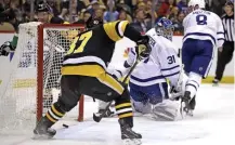  ?? AP ?? OH YEAH THAT GUY: Penguins forward Sidney Crosby scores on Toronto goalie Frederik Andersen in the second period Tuesday during a 4-point night.