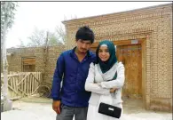  ?? (AP/Nursimangu­l Abdureshid) ?? Memetali Abdureshid poses for a photo with his sister Nursimangu­l Abdureshid in August 2013 outside their family home in
Sayibage township in China’s far west Xinjiang region in August 2013. Memetali Abdureshid, who ran a car repair shop, was listed as being sentenced to 15 years and 11 months in prison on charges of “picking quarrels and provoking trouble” and “preparing to carry out terrorist activities.”