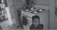  ?? Jon Shapley / Staff photograph­er ?? Kaiden Antoine, 3, stands by the stove, his family’s only source of heat after power went out Tuesday at Cuney Homes in Houston. Experts warn using a gas stove this way poses risk of carbon monoxide and fire.
