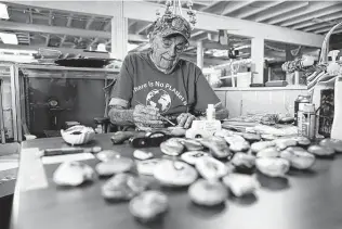  ?? Cassie Stricker / Bryan-college Station Eagle ?? Kenny Bergmann, an 83-year-old volunteer greeter at the Bryan-college Station Habitat for Humanity Restore, works on painting rocks that he sells for a $1 donation.