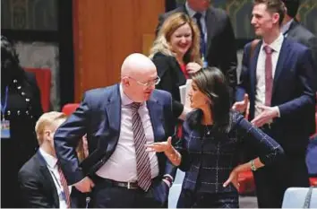  ?? Reuters ?? Russian Ambassador to the UN Vassily Nebenzya and US envoy Haley speak before a United Nations Security Council meeting at the UN headquarte­rs in New York on Tuesday.